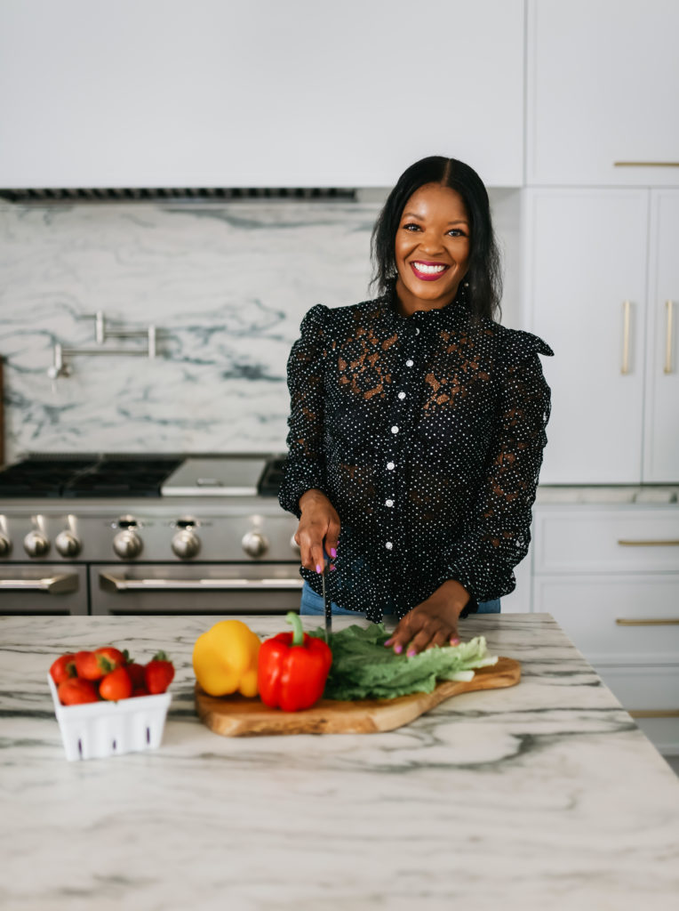 Brandi Crawford in the kitchen chopping vegetables