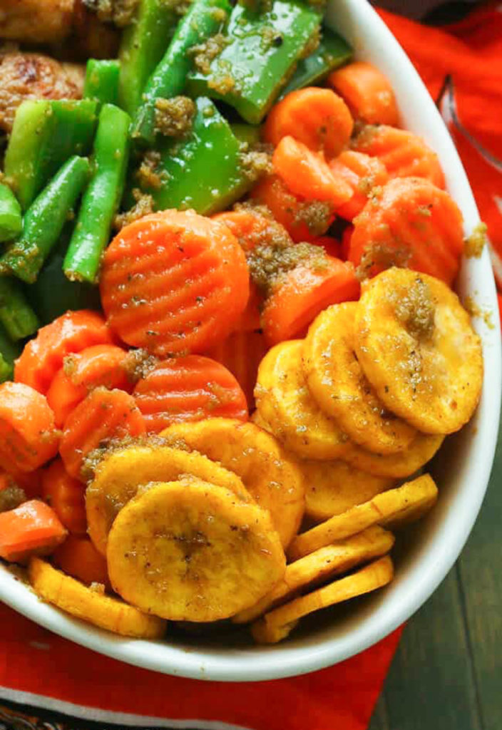 Green beans, carrots, and fried plantains in a white bowl.