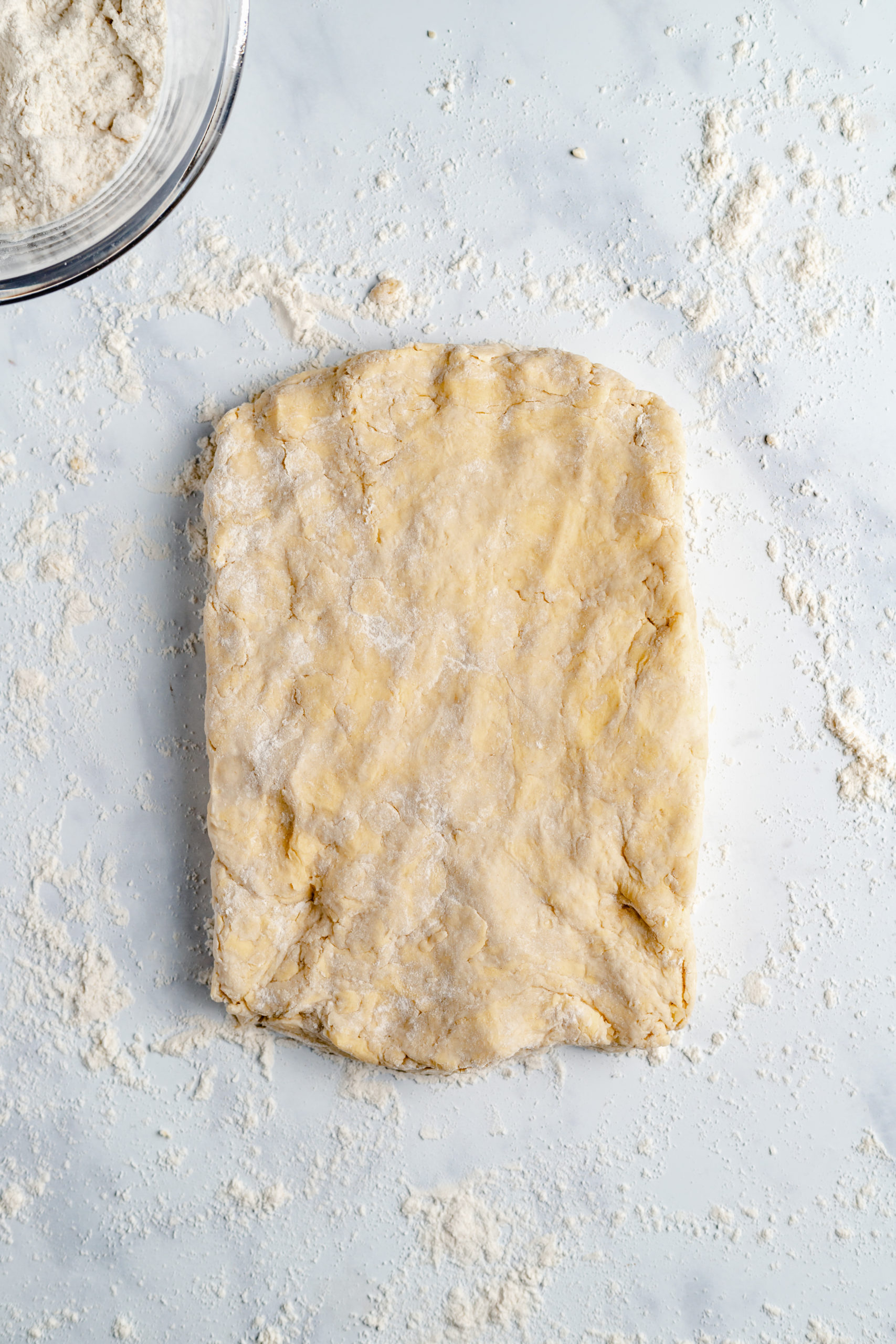 A Rolled-Out Slab of Vegan Biscuit Dough on a White Counter