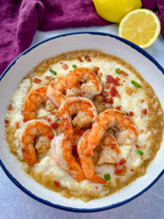 black folks shrimp and grits on a plate with bacon