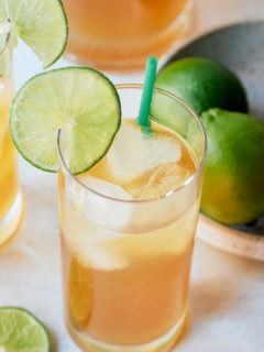 overhead photo of Jamaican lemonade with limes in the background