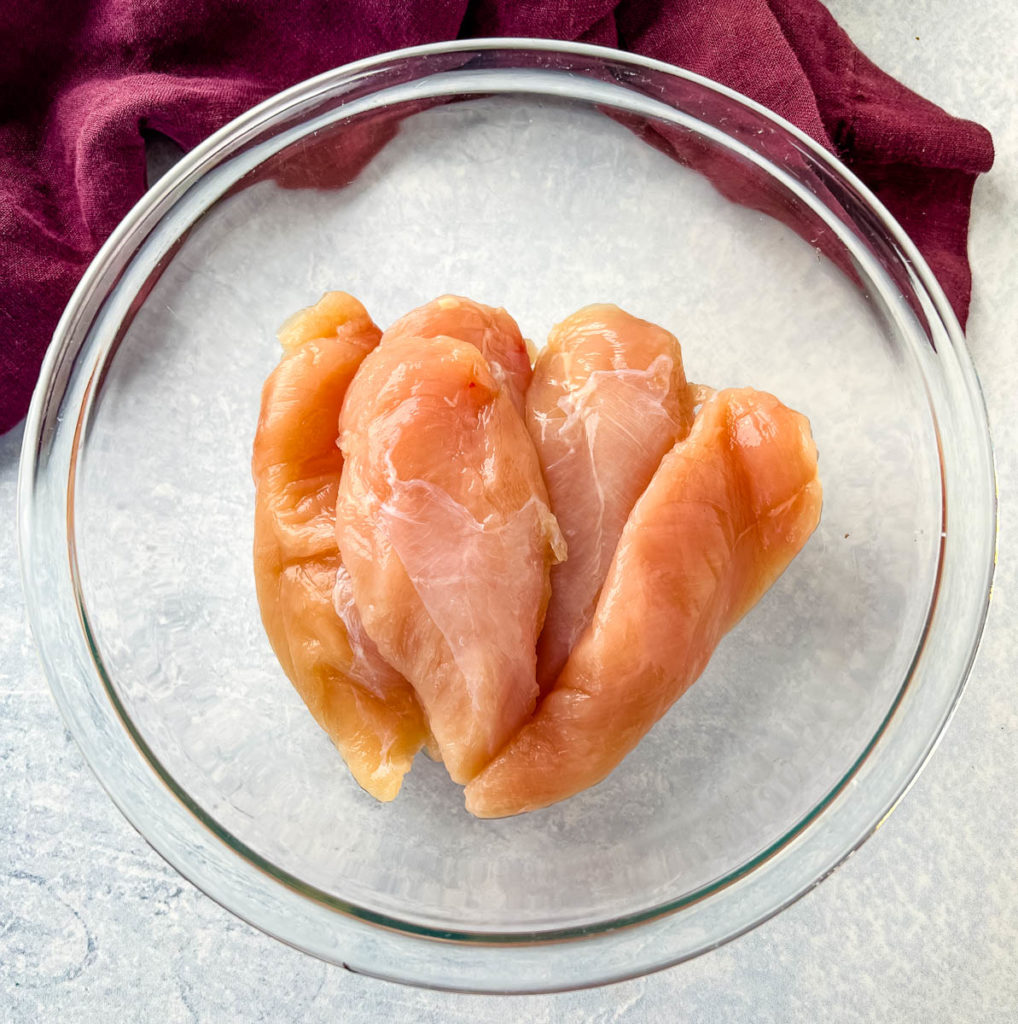 raw chicken tenders in a glass bowl