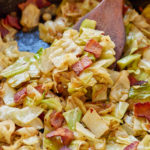 cabbage and bacon in skillet with spatula