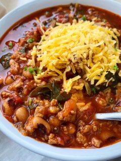 southern soul food chili in a white bowl with cheese on top