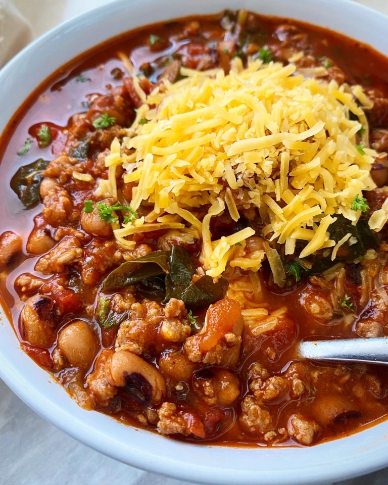 southern soul food chili in a white bowl with cheese on top