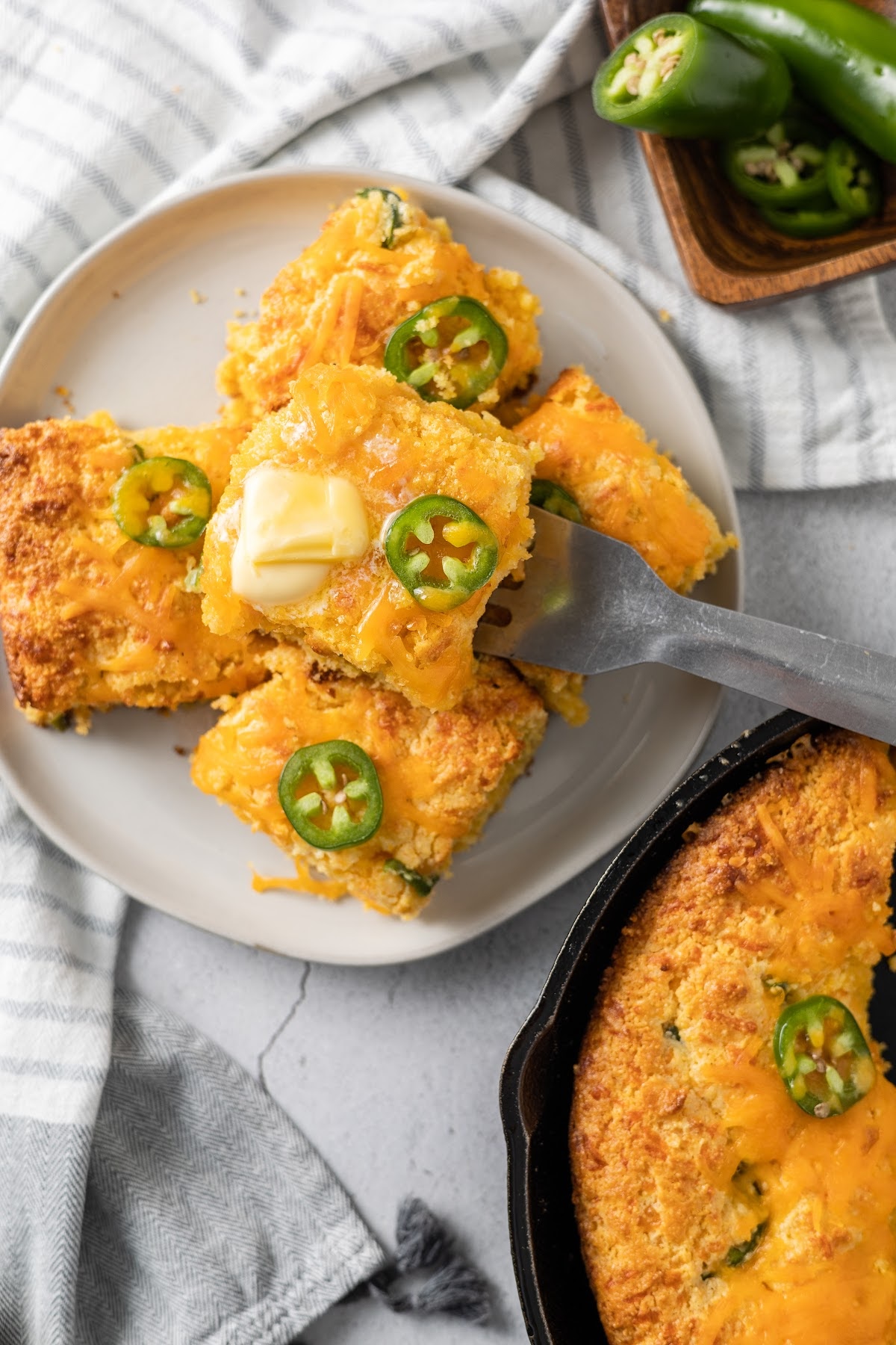 jiffy jalapeno cheddar cornbread in a cast iron skillet and on a plate