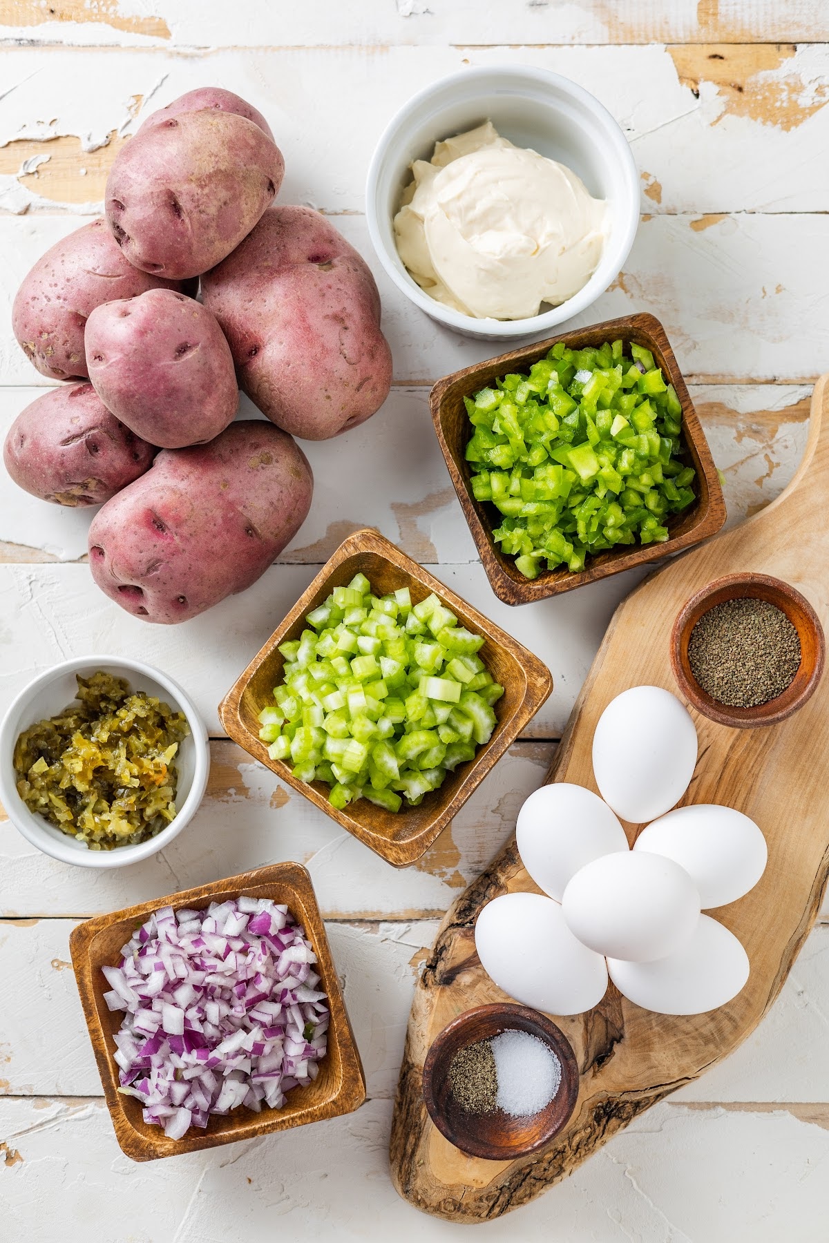 red potatoes, mayo, celery, red onions, green peppers, eggs, salt and pepper in separate bowls