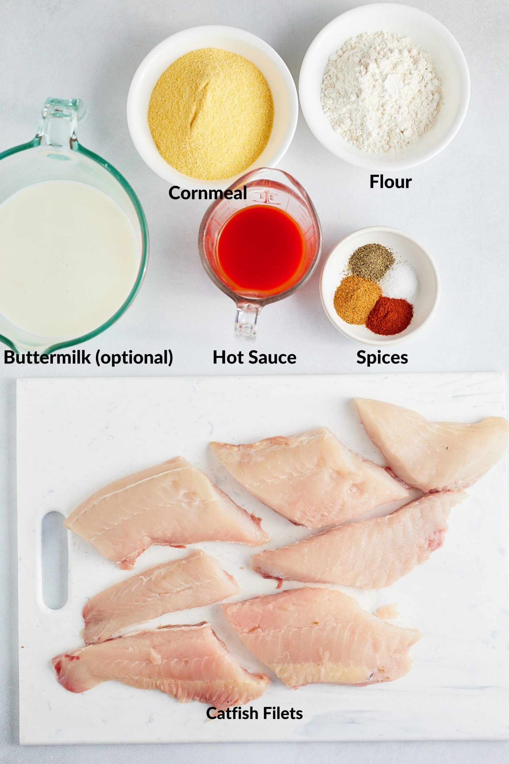 ingredients of southern fried catfish on white board