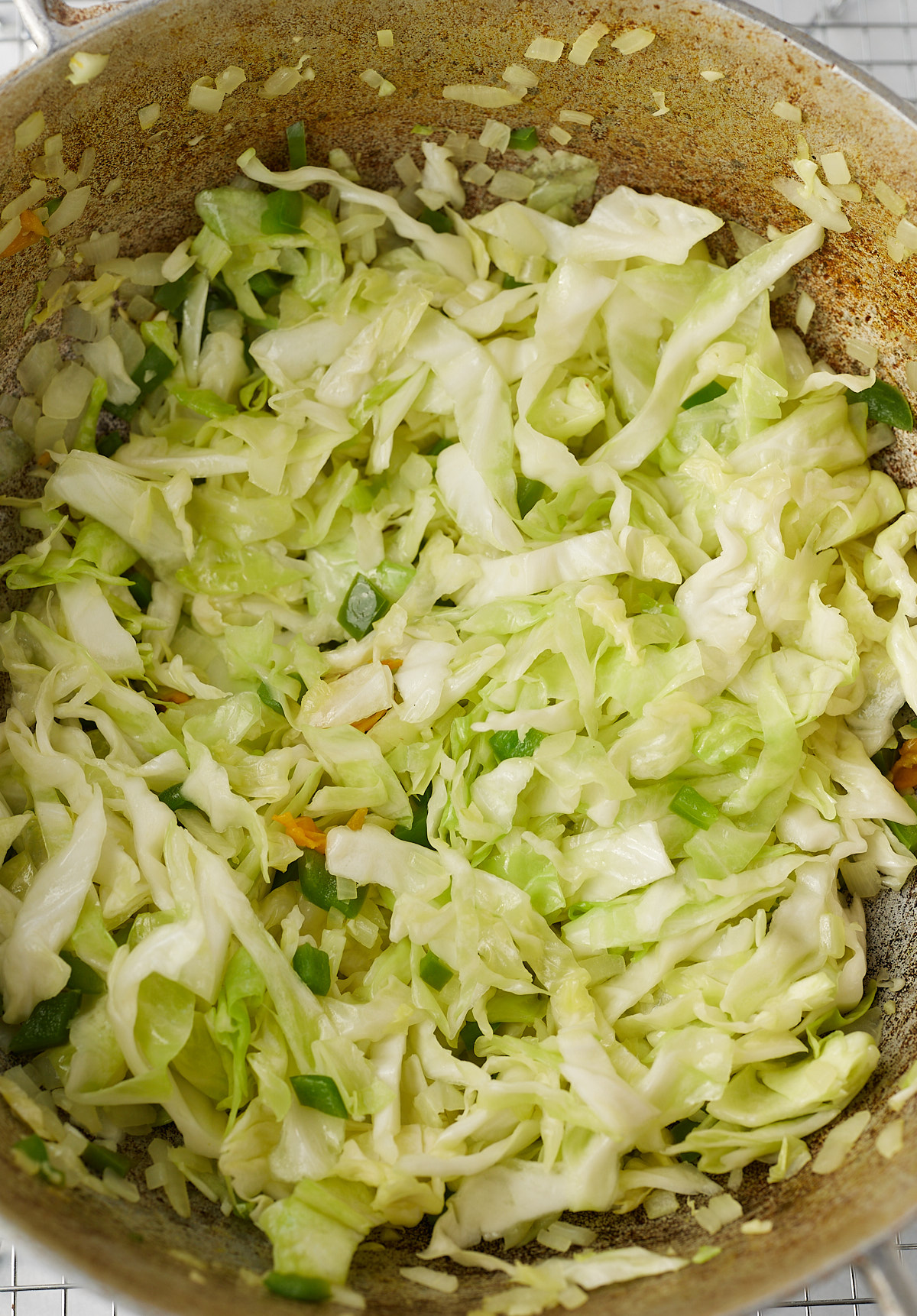 cabbage that has been cooked with bell peppers and onions