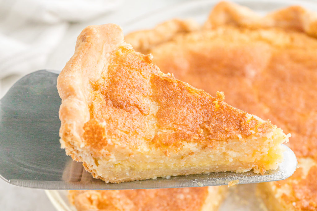 A slice of Southern custard pie being lifted before serving.