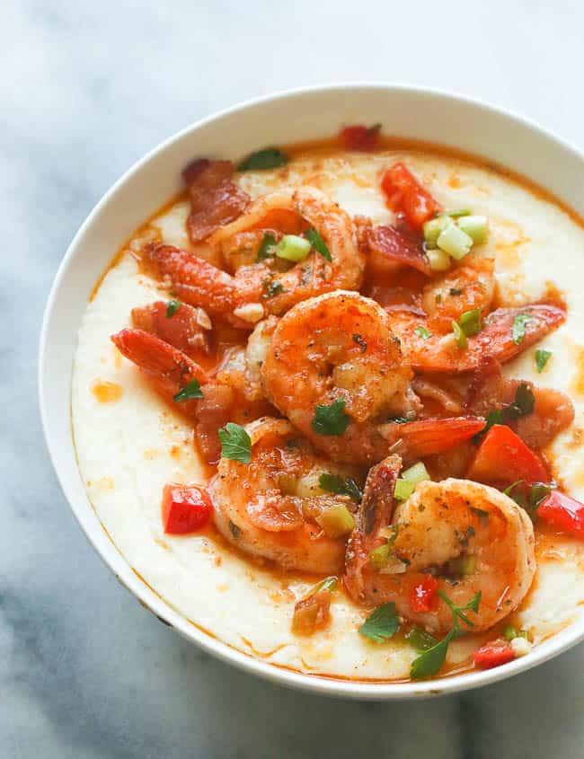 Cajun shrimp topping a bowl of creamy grits