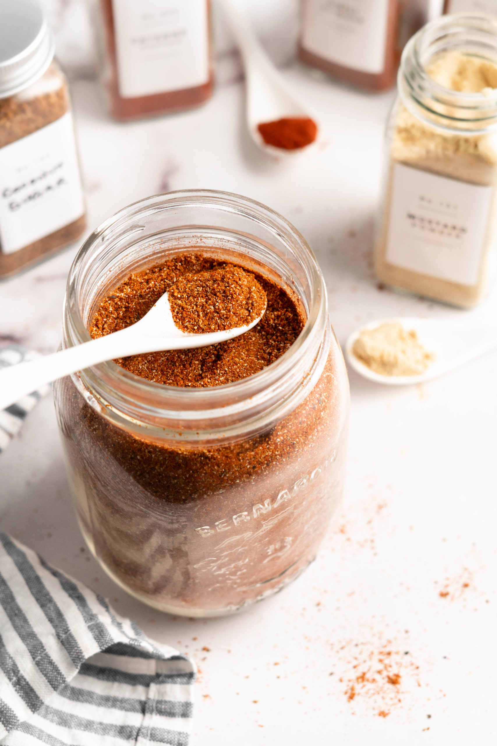 Spoonful of spice rub set on top of jar