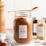 BBQ spice rub in jar with spoon set over top