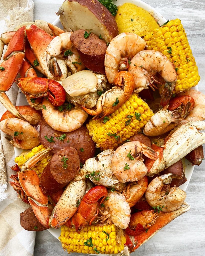 cooked seafood boil on a white platter