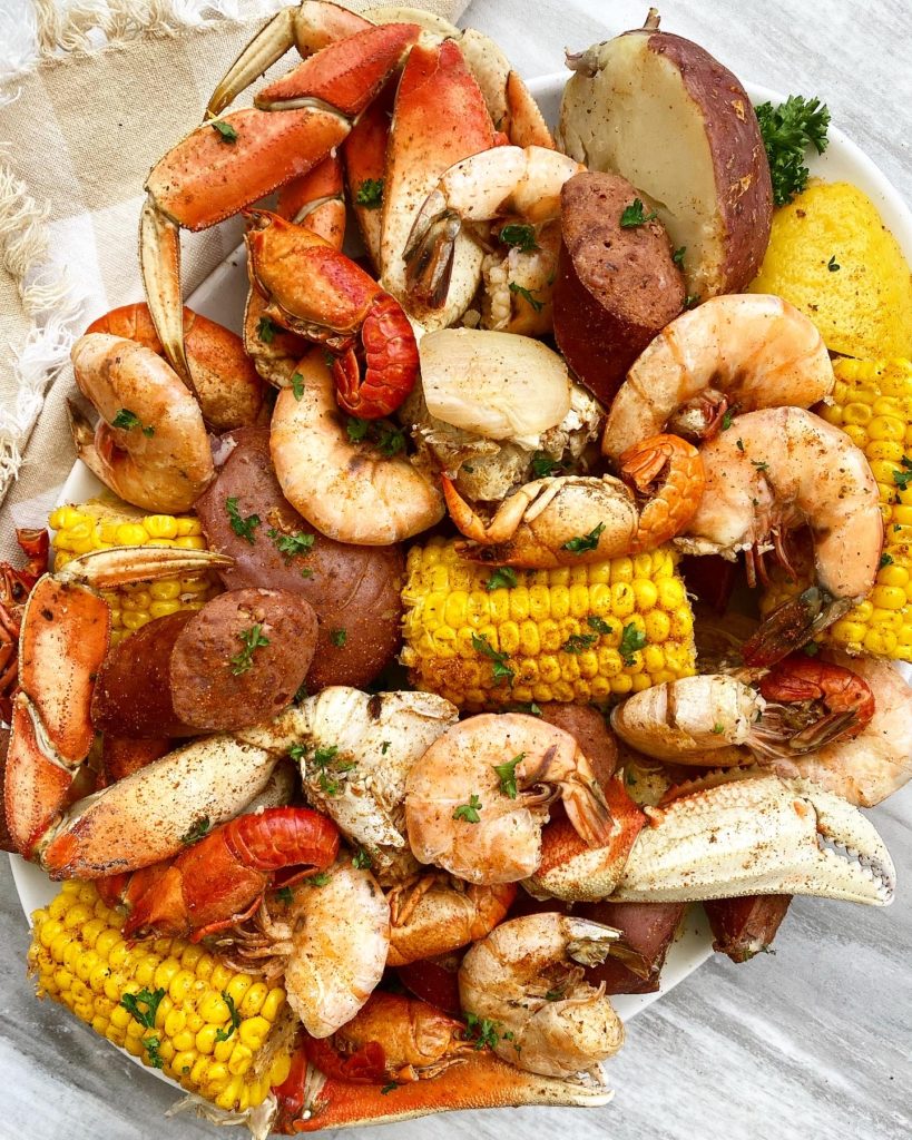 overhead shot of seafood boil on a white plate