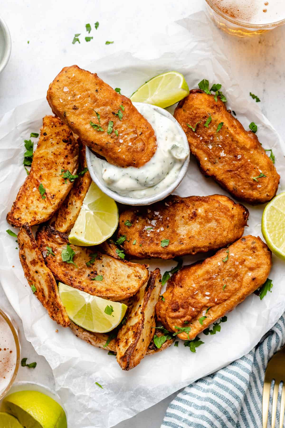 Vegan Fish Sticks on a plate with one in vegan tartar sauce