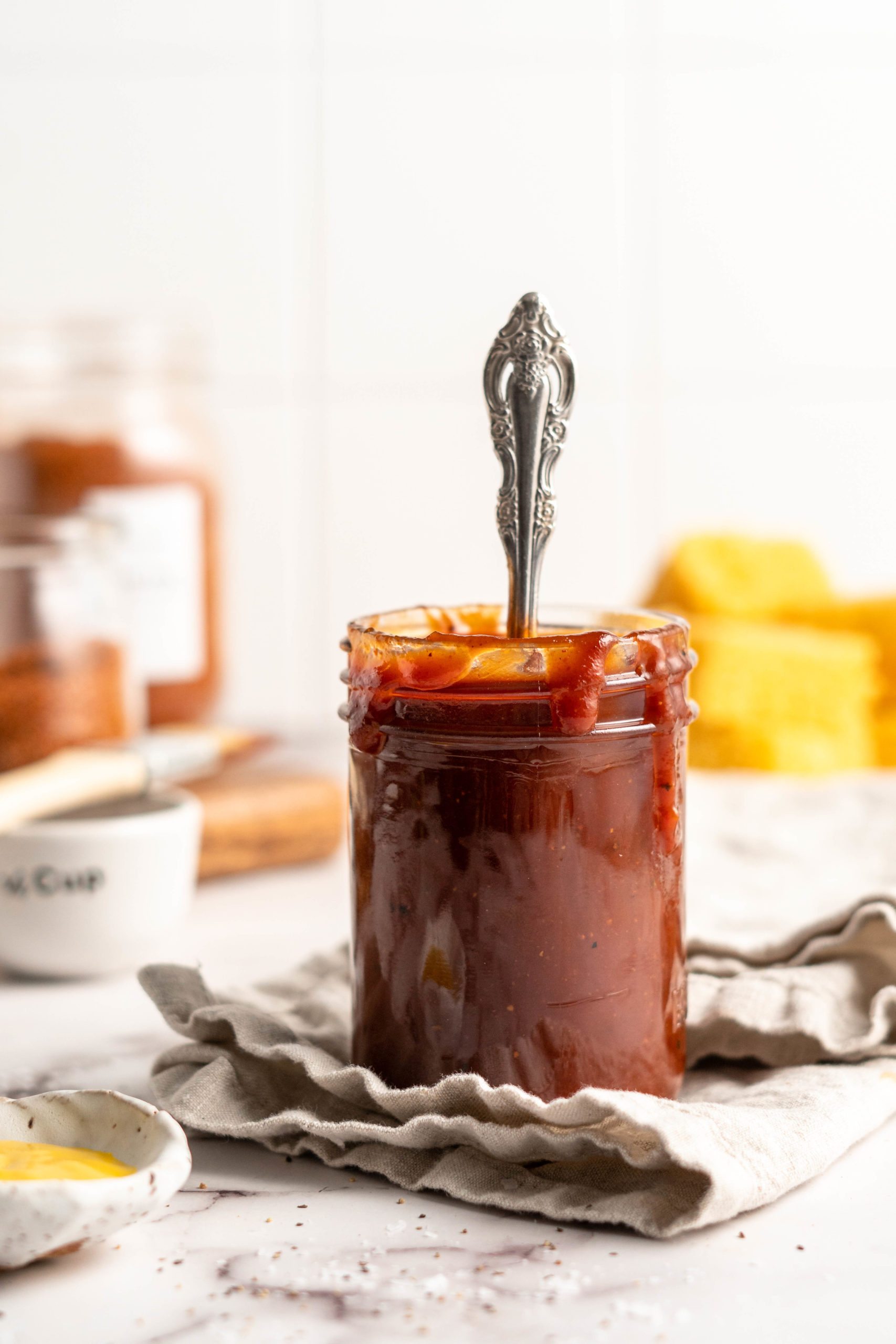 Barbecue sauce in jar with spoon