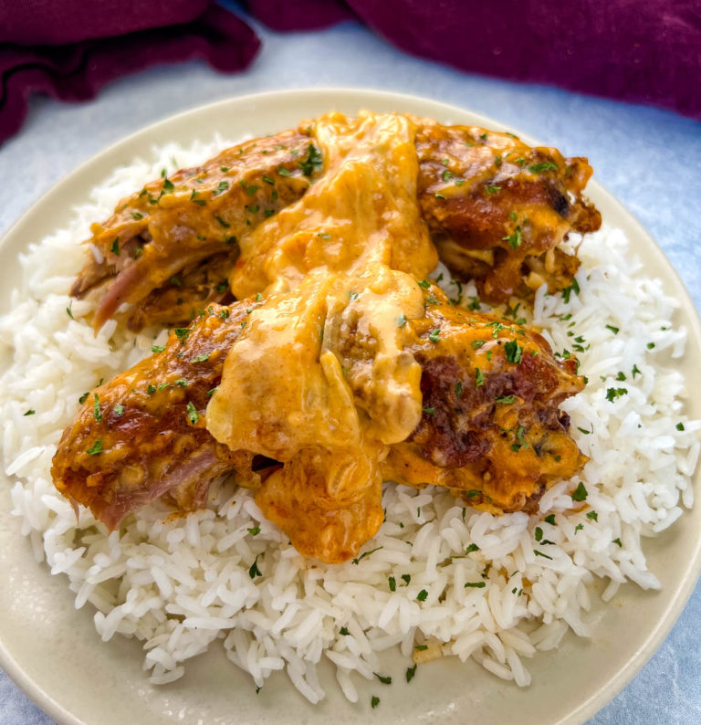smothered turkey necks with gravy and rice on a plate