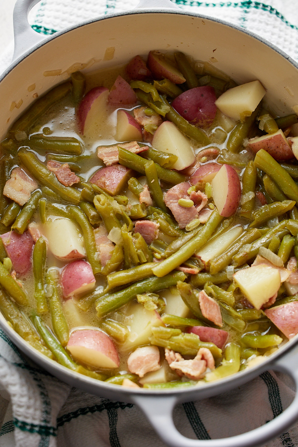 cooked green beans and potato in pot