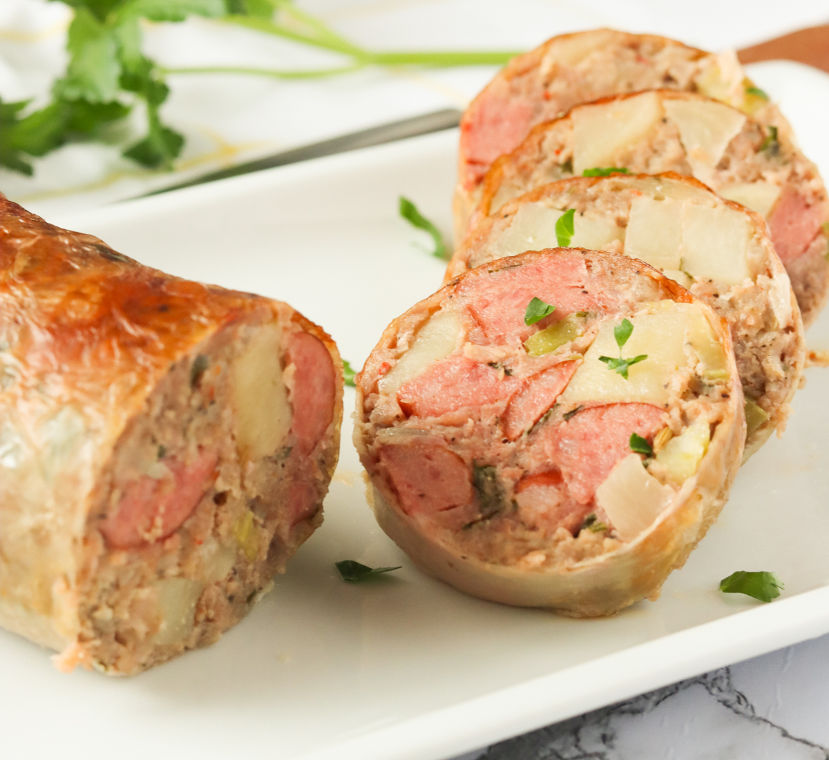 Stuffed hog maws sliced on a white plate