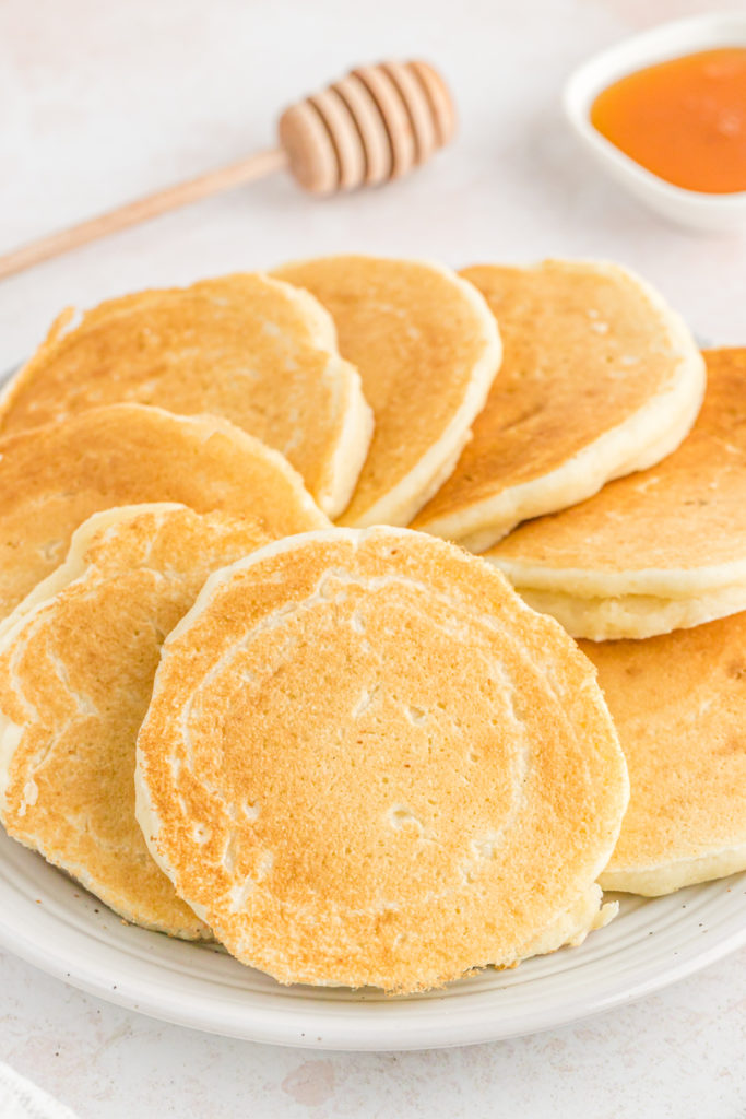 Hoecakes on a white plate fanned around in a circle ready to enjoy