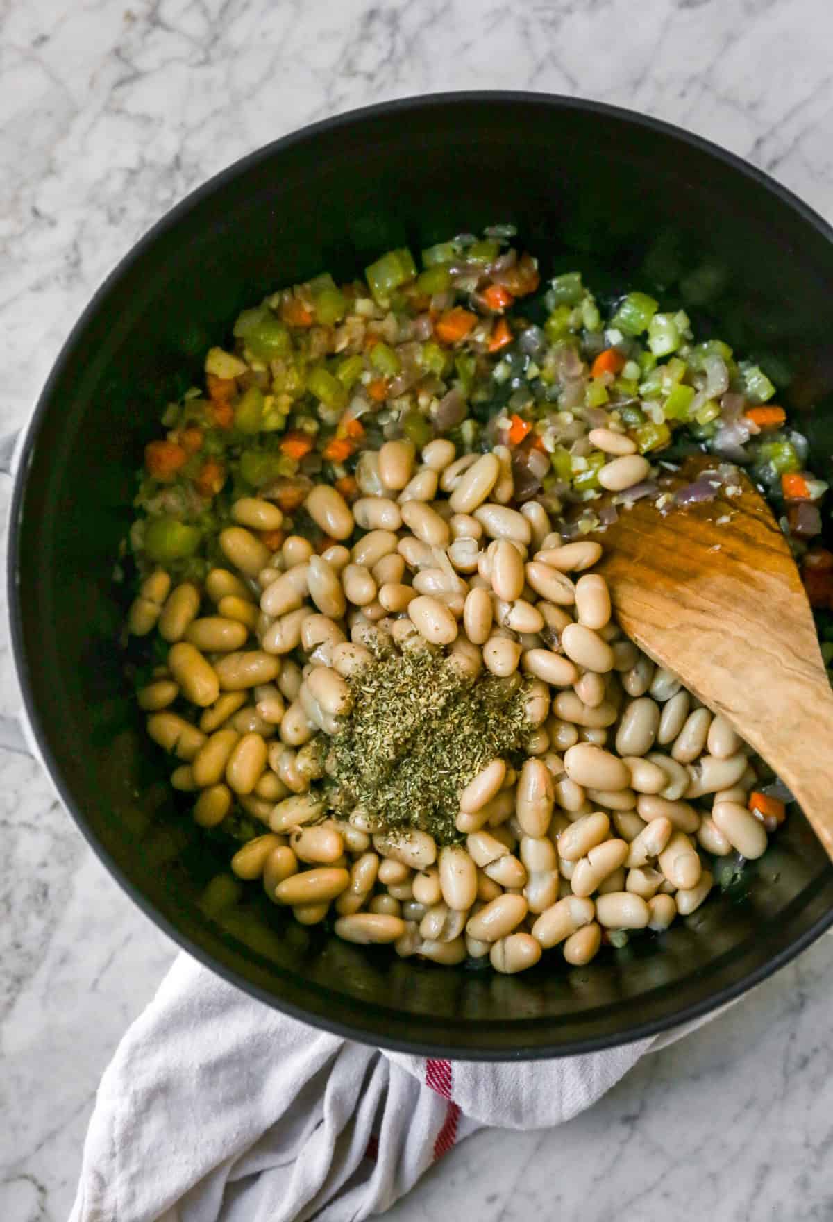 White beans in pot with other soup ingredients
