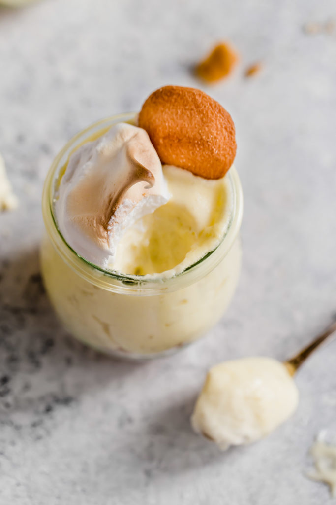 A pot of banana pudding with some eaten ready to enjoy