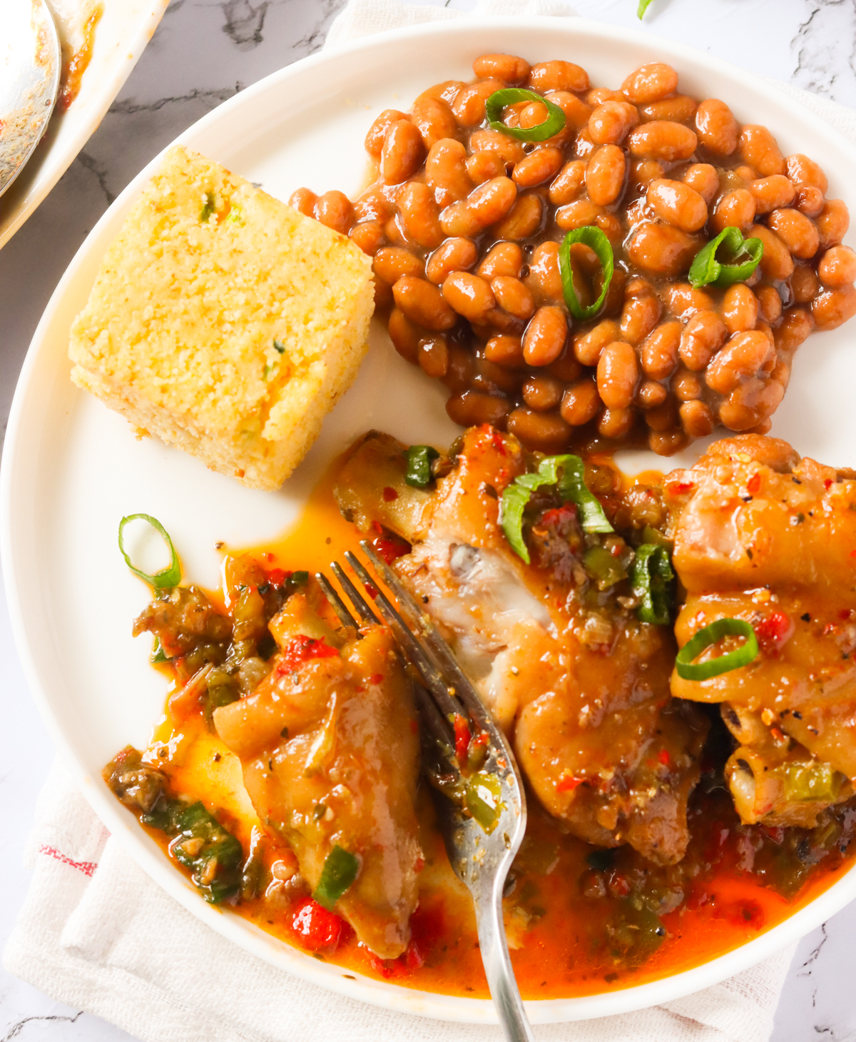 A plate of pig's feet, cornbread, and beans