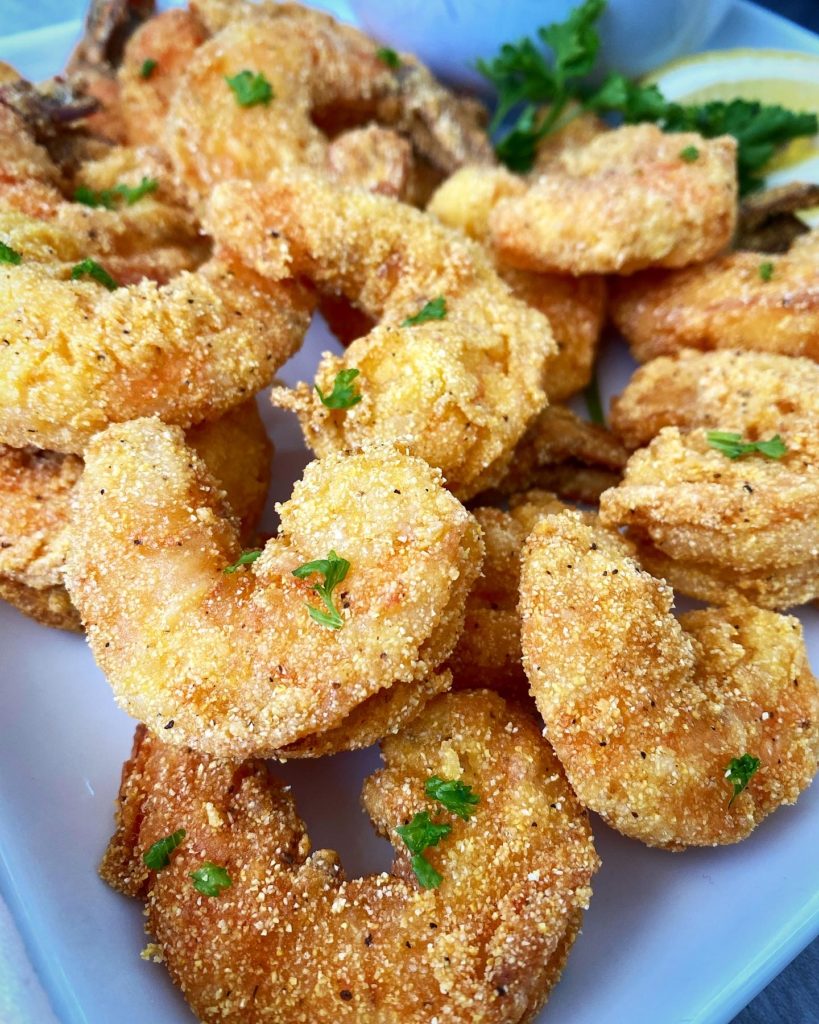 close up of fried shrimp on a white plate