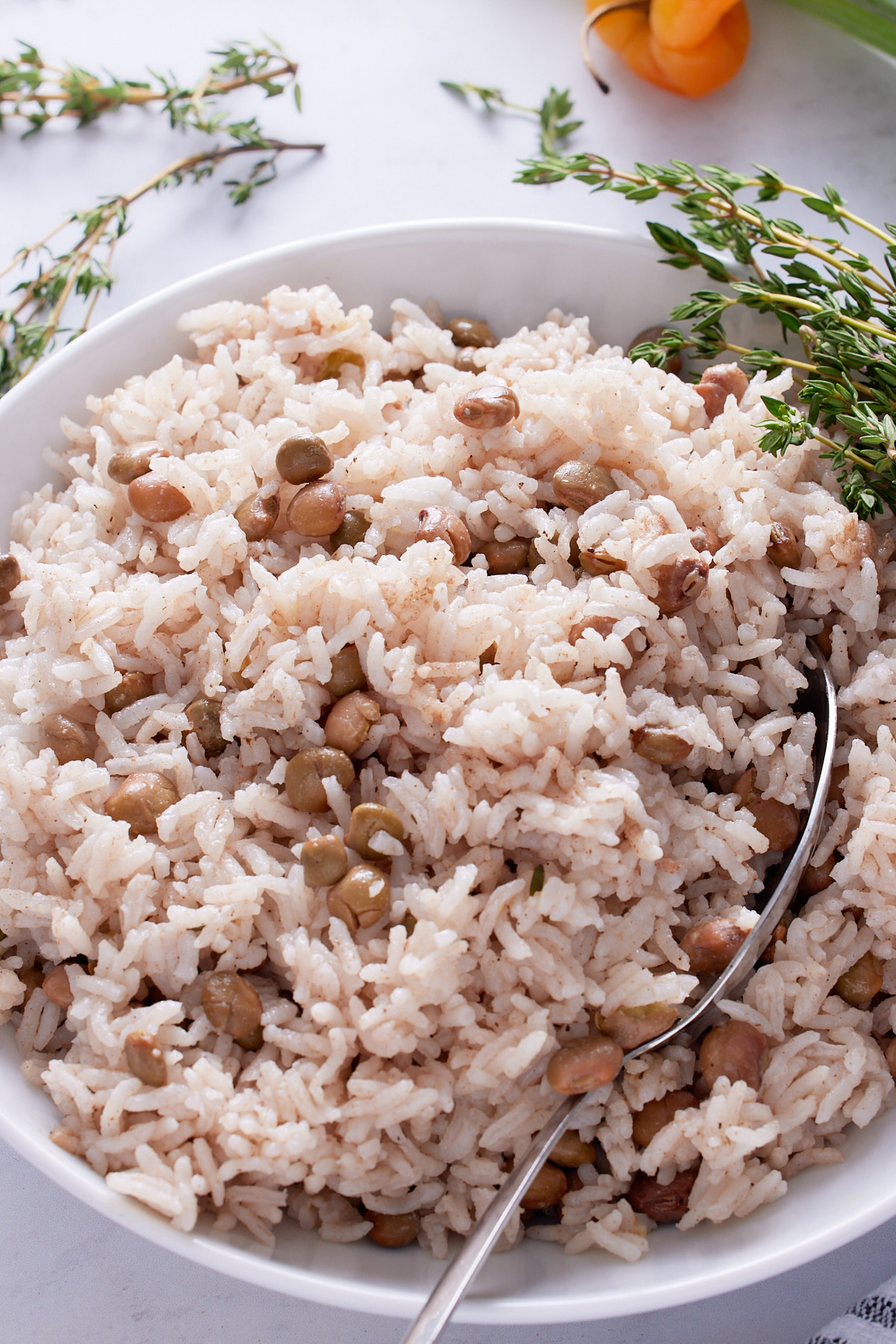 gungo peas and rice in white bowl with spoon sticking out of it