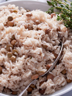 gungo peas and rice in white bowl with spoon sticking out of it