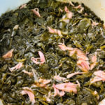 cooked turnip greens in a pot with smoked turkey