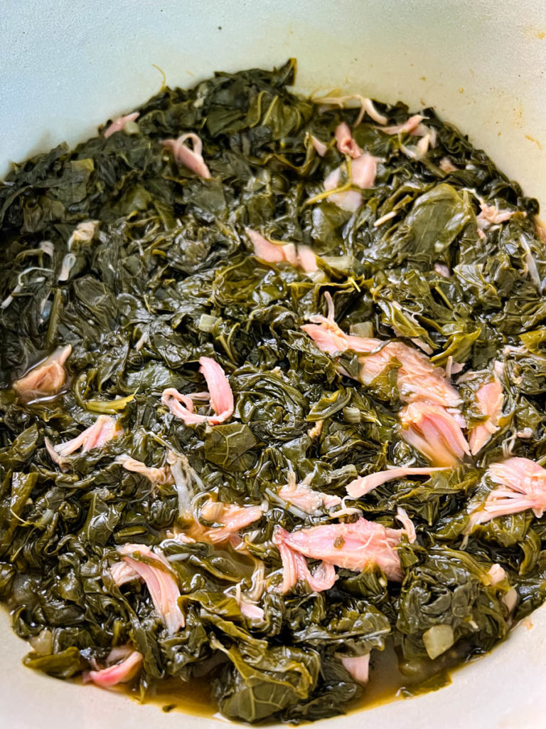 cooked turnip greens in a pot with smoked turkey