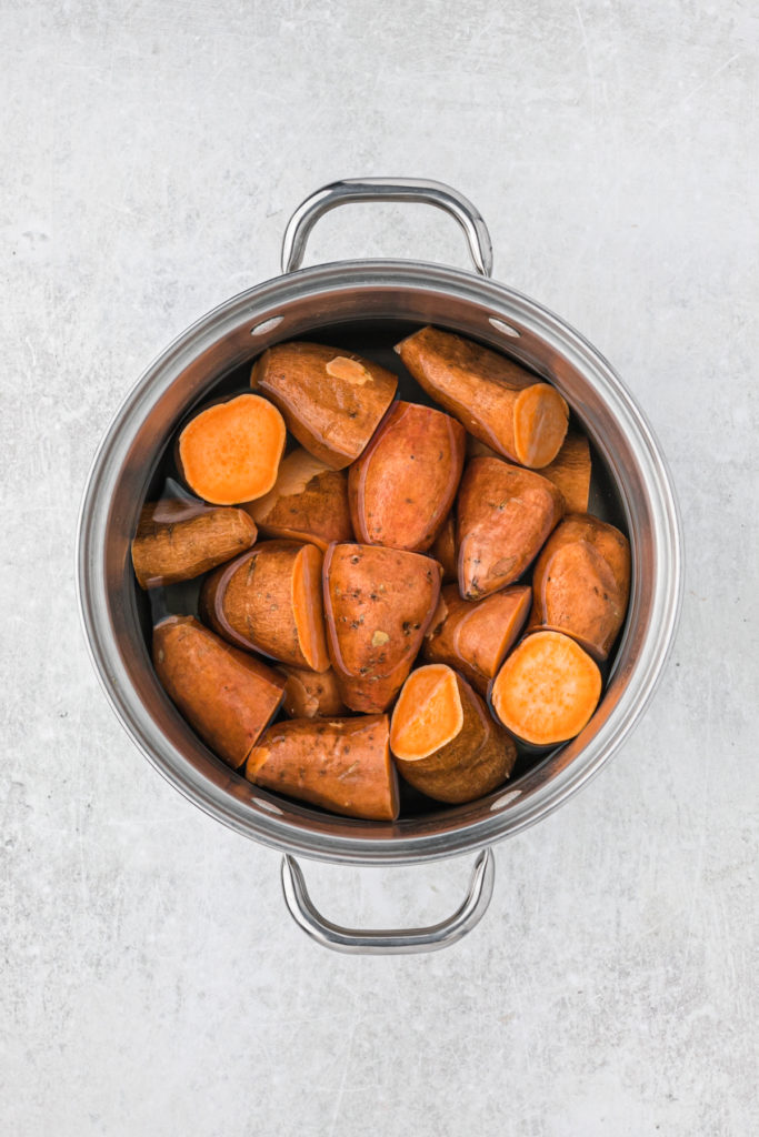 Boiled sweet potato chunks in a small pot
