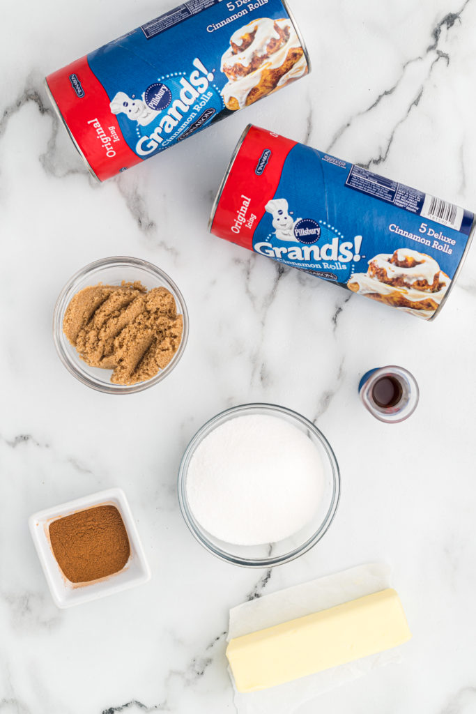 cinnamon roll dough, sugar, cinnamon and vanilla in separate bowls