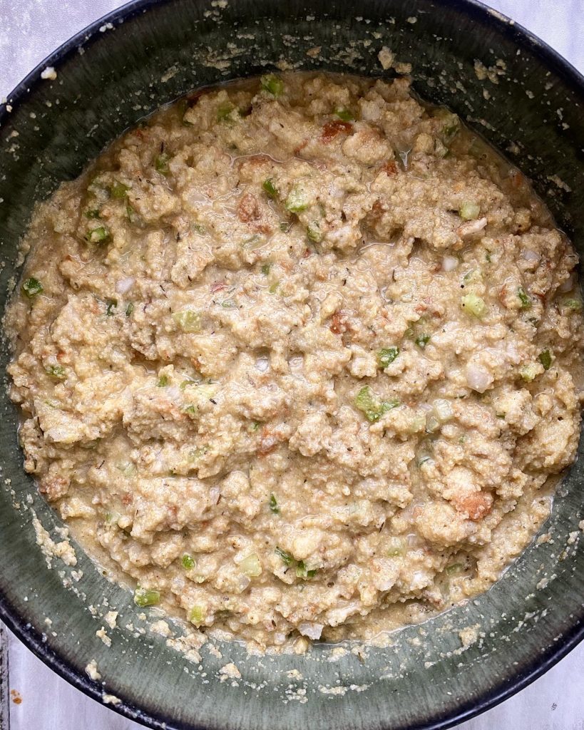 uncooked cornbread dressing ingredients in a black bowl