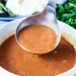 Finished brown gravy in a white bowl