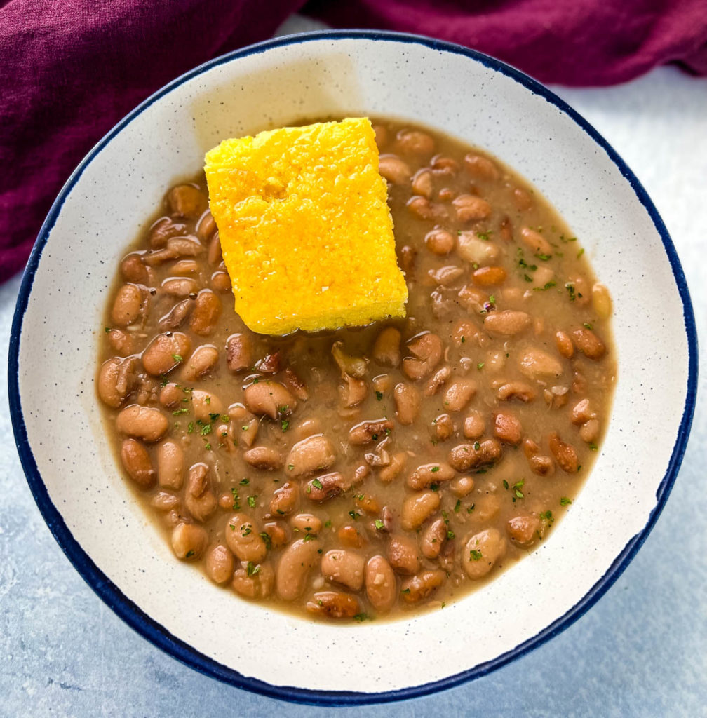 Southern pinto beans and cornbread in a white bowl