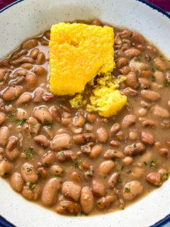 Southern pinto beans and cornbread in a white bowl