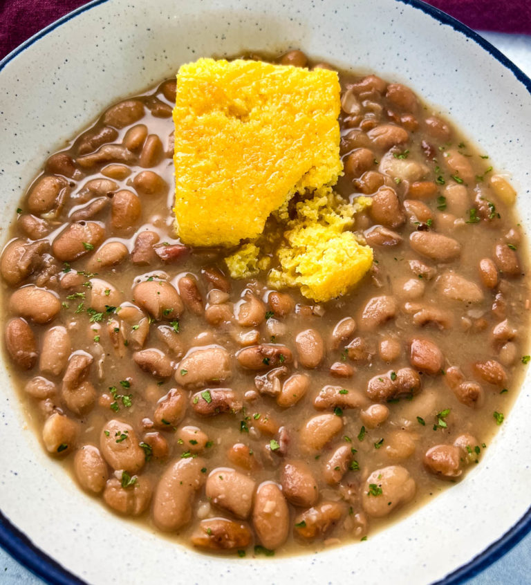 Southern pinto beans and cornbread in a white bowl