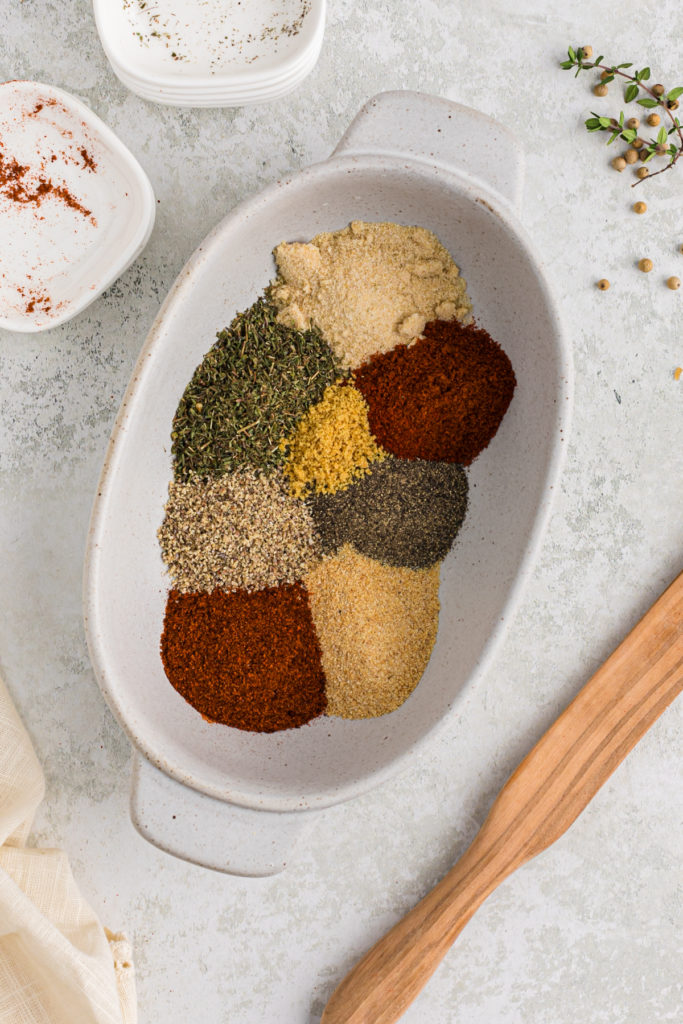 Various spices and herbs in a large white pan