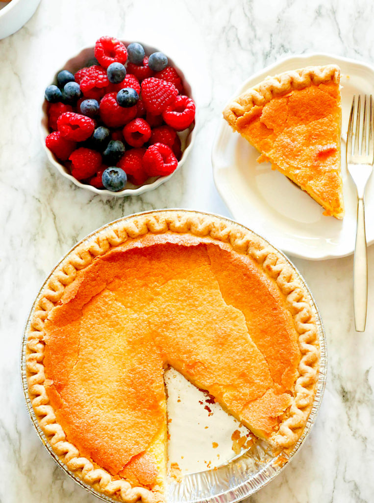 Southern chess pie sliced and served with fresh berries