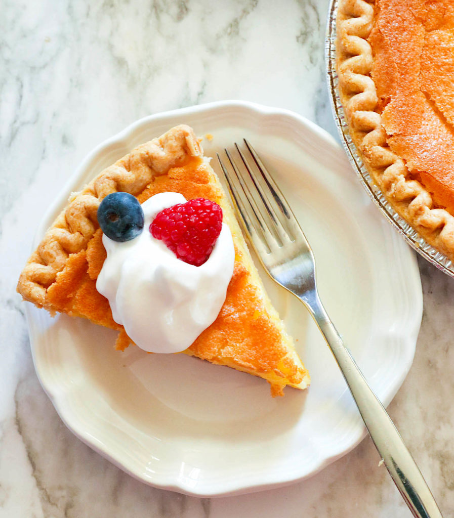Decadent Southern chess pie with whipped cream and fresh berries