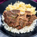 Southern beef neck bones on a plate with rice and cabbage
