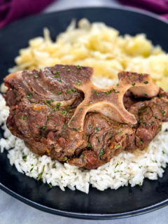 Southern beef neck bones on a plate with rice and cabbage