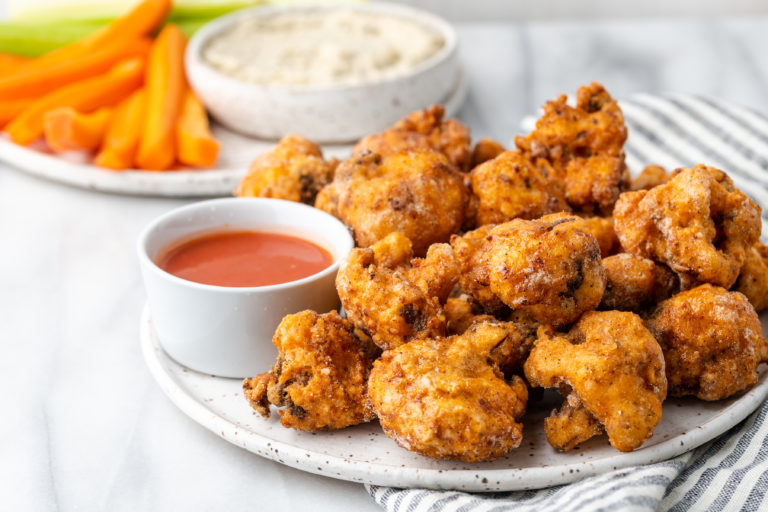 Southern Fried Cauliflower on a plate with hot sauce