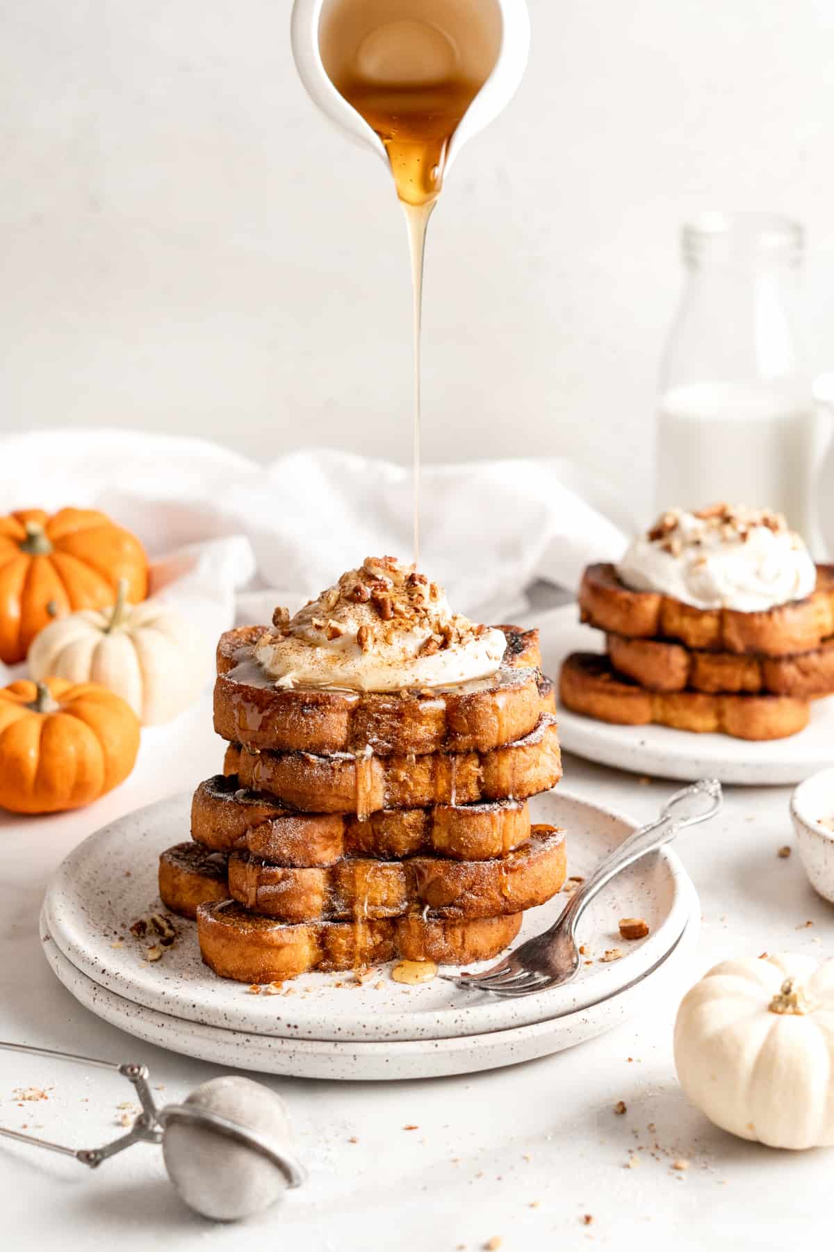 plate of pumpkin French toast with maple syrup dripping down