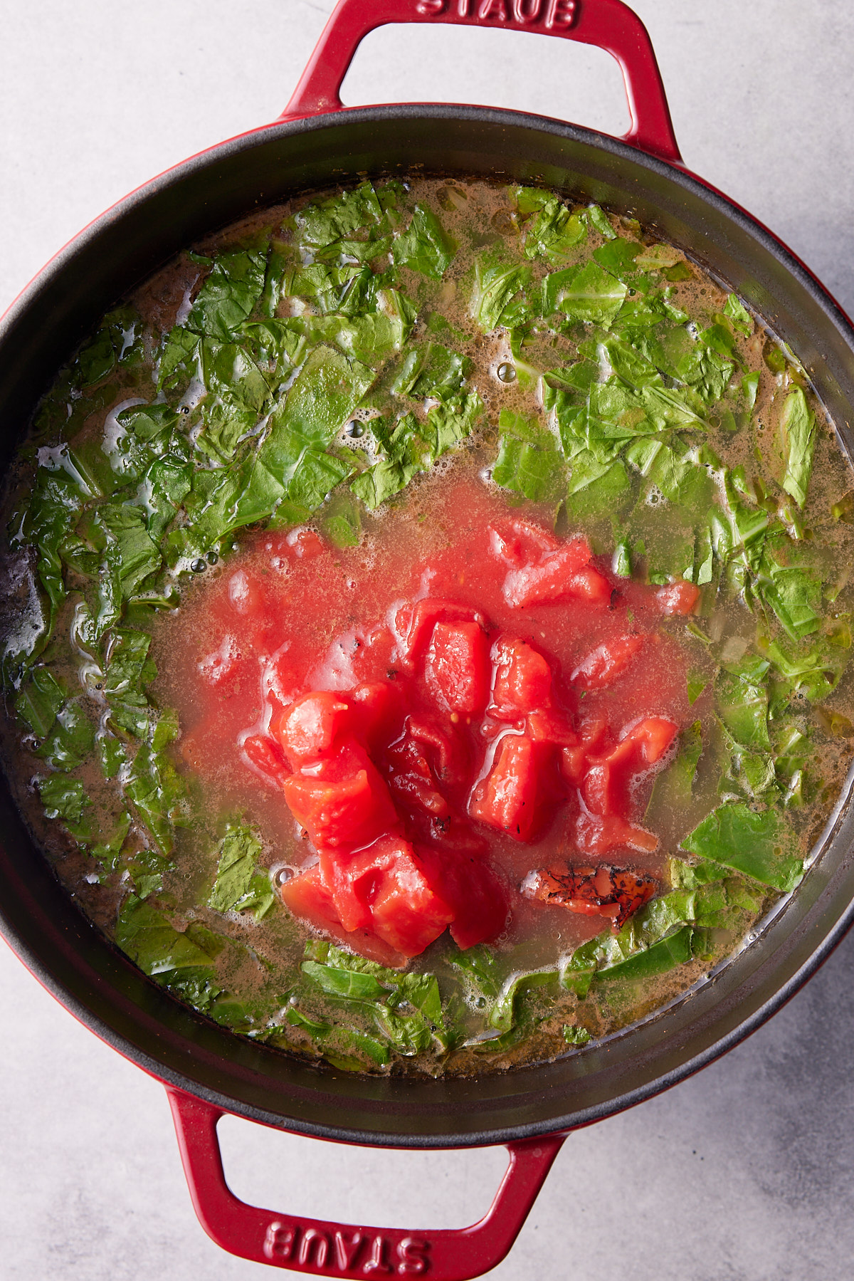 collard greens and fire roasted tomatoes in pot