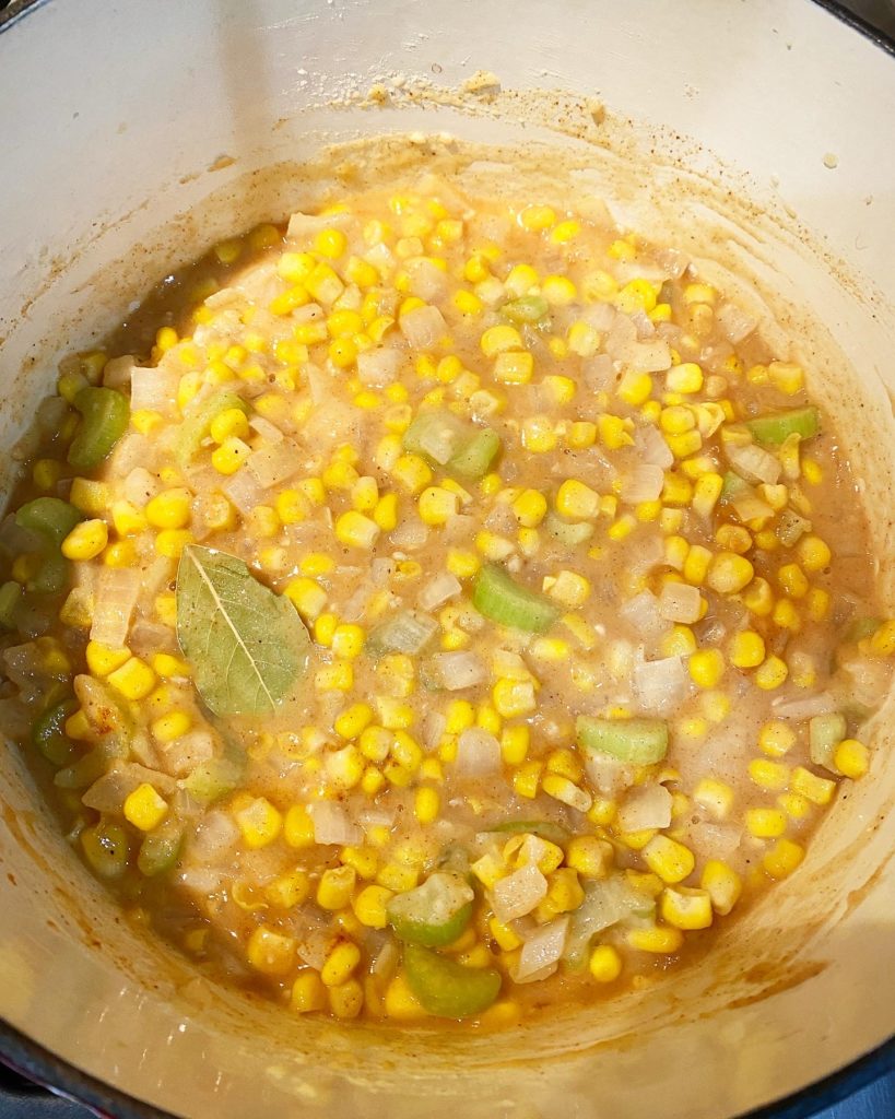 overhead shot of corn, roux, and bay leaf in uncooked corn & crab bisque