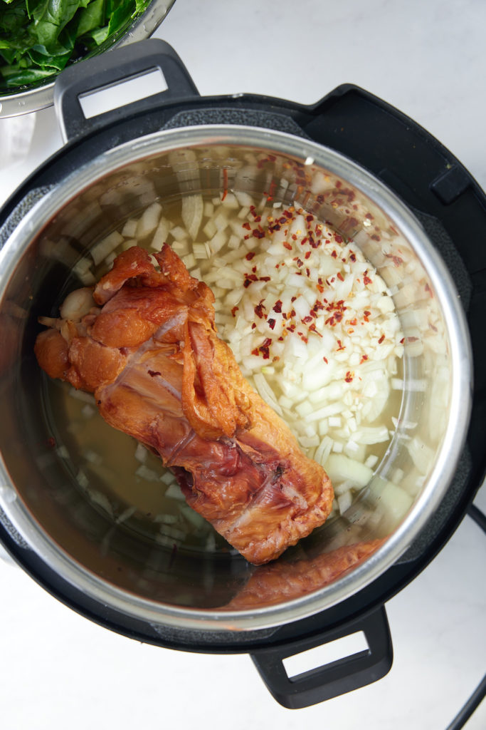 chicken broth, onions, and turley meat in instant pot insert